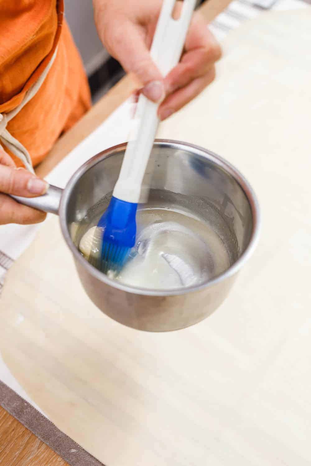 Teig mit Butter bestreichen